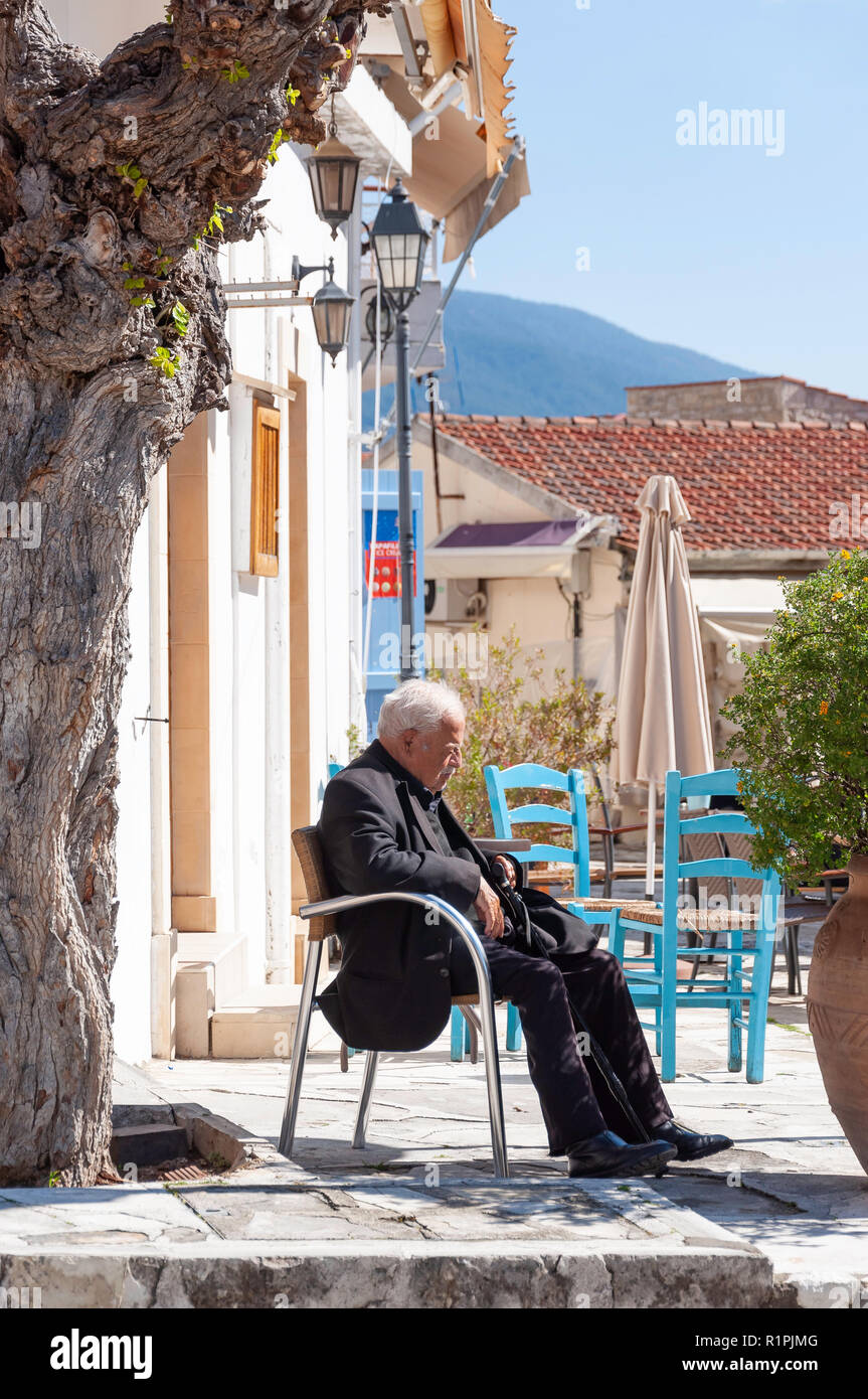 Old, local man sleeping in the sun, Omodos Square, Omodos (Troodos Mountains), Limassol District, Republic of Cyprus Stock Photo