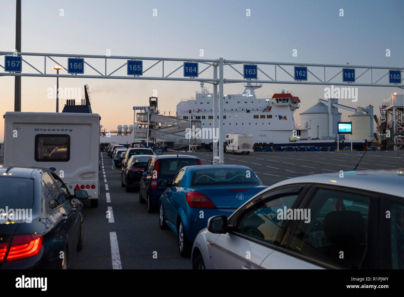 Waiting for a ferry at the calais port, queues of cars, dusk, france Stock Photo