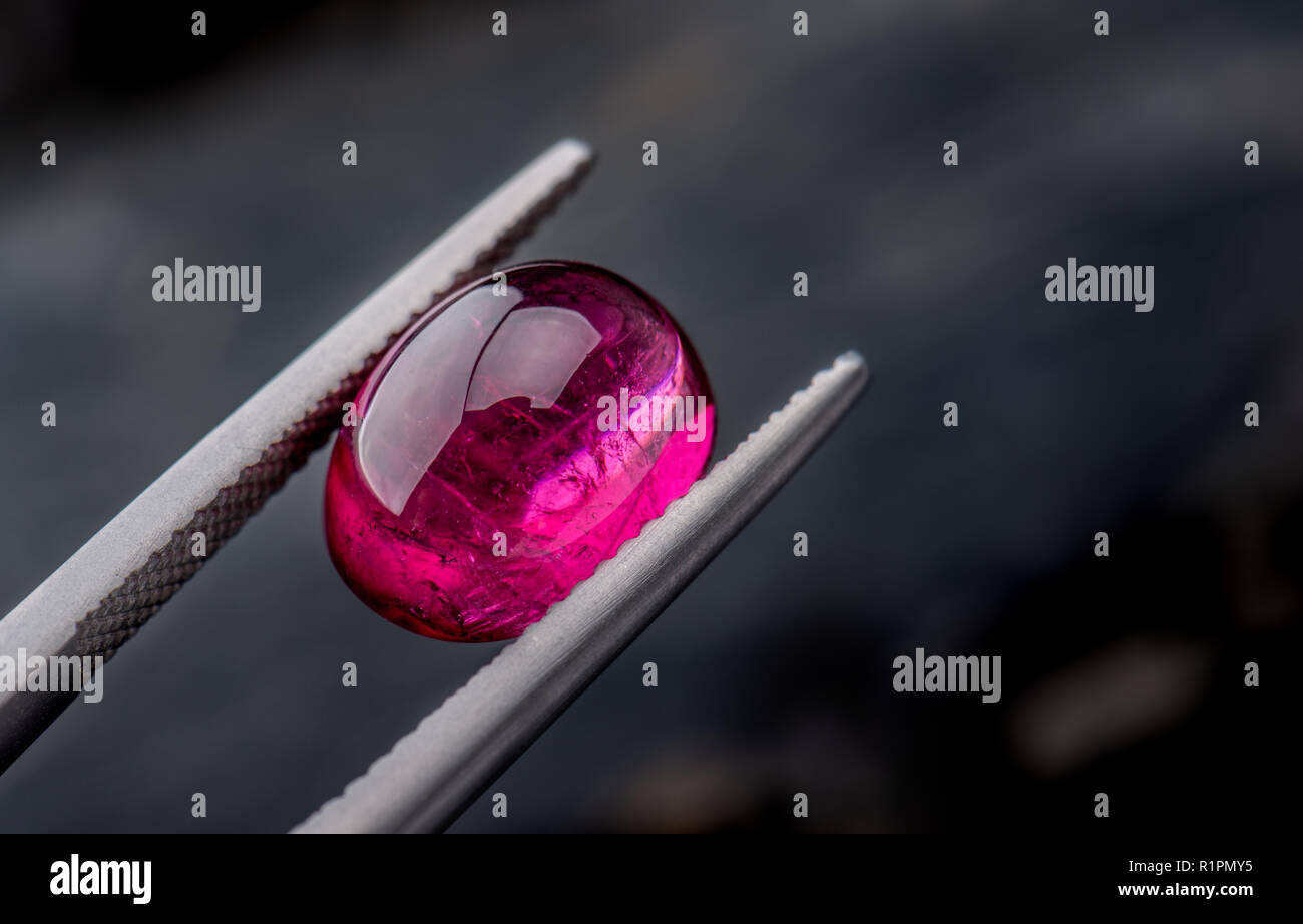 Rubellite gemstone jewelry photo with dark lighting background Stock