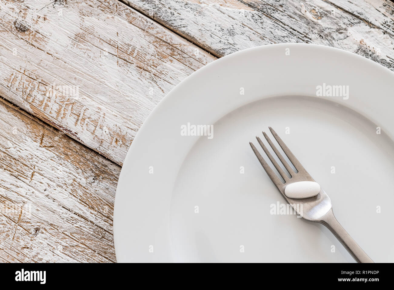 Tablets with silver fork on an old wooden table Stock Photo