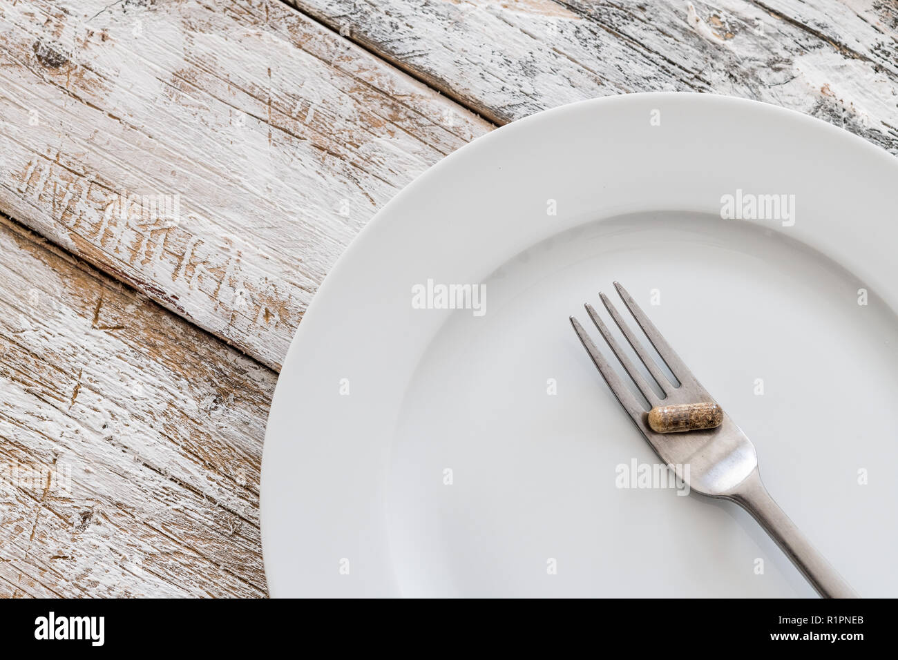 Tablets with silver fork on an old wooden table Stock Photo