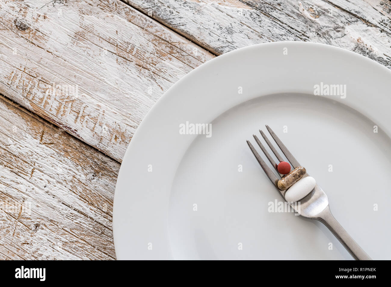 Tablets with silver fork on an old wooden table Stock Photo