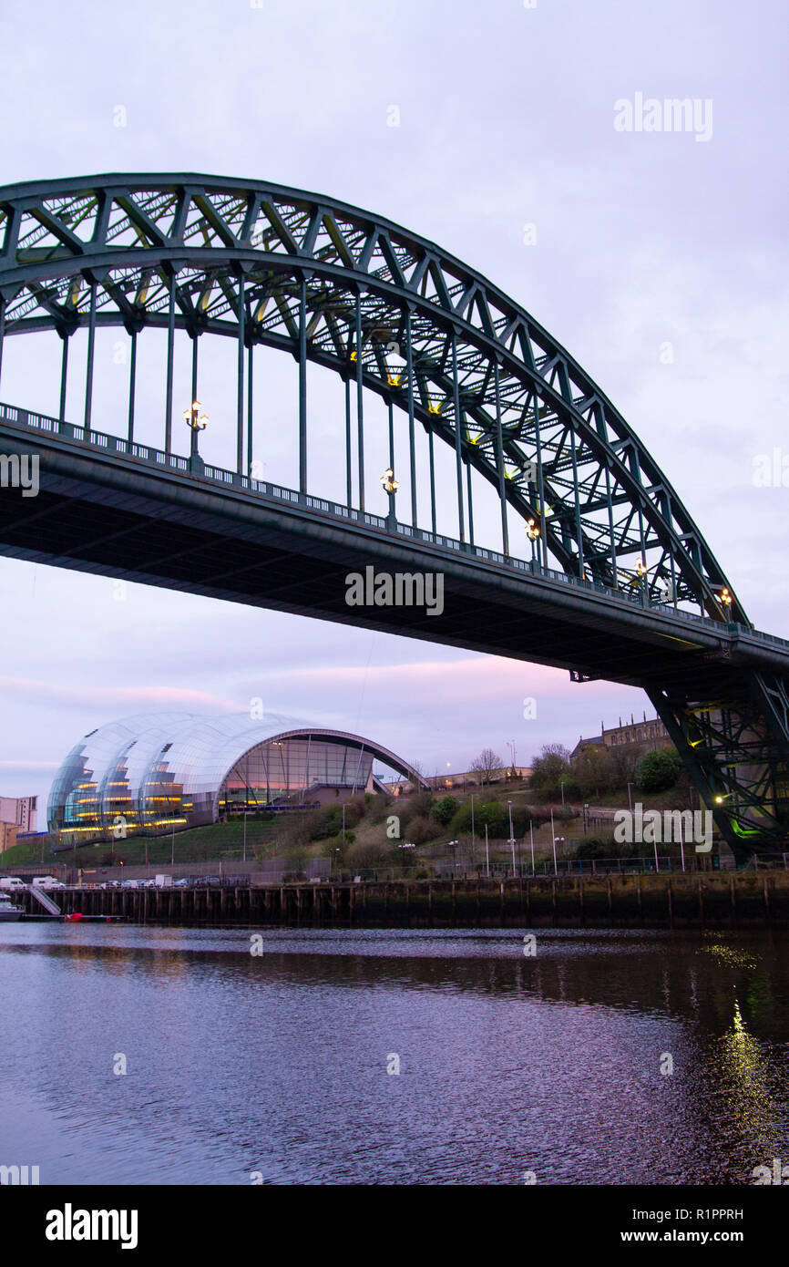 Newcastle upon Tyne: River Tyne view from Swing Bridge with Tyne Bridge and Gateshead Sage at dusk with purple sunset Stock Photo