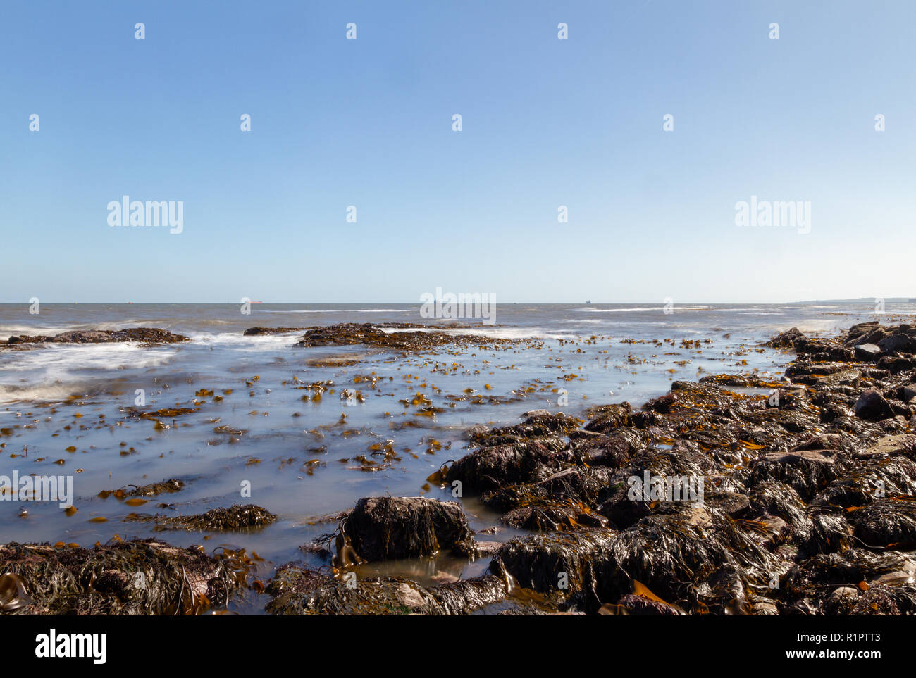 Rocky beach water waves with slow shutter motion blur Stock Photo