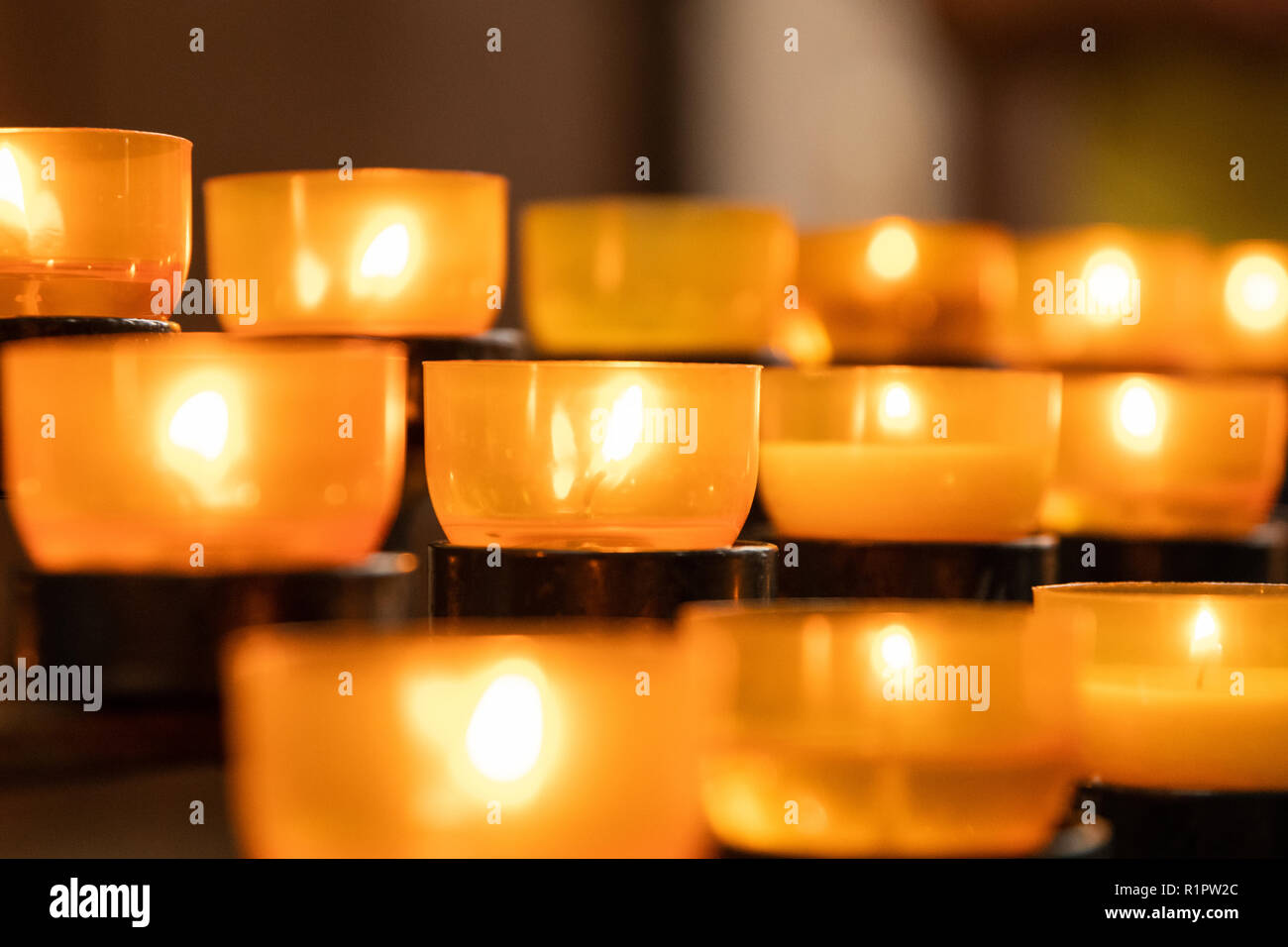 Lit church candles with warm light Stock Photo
