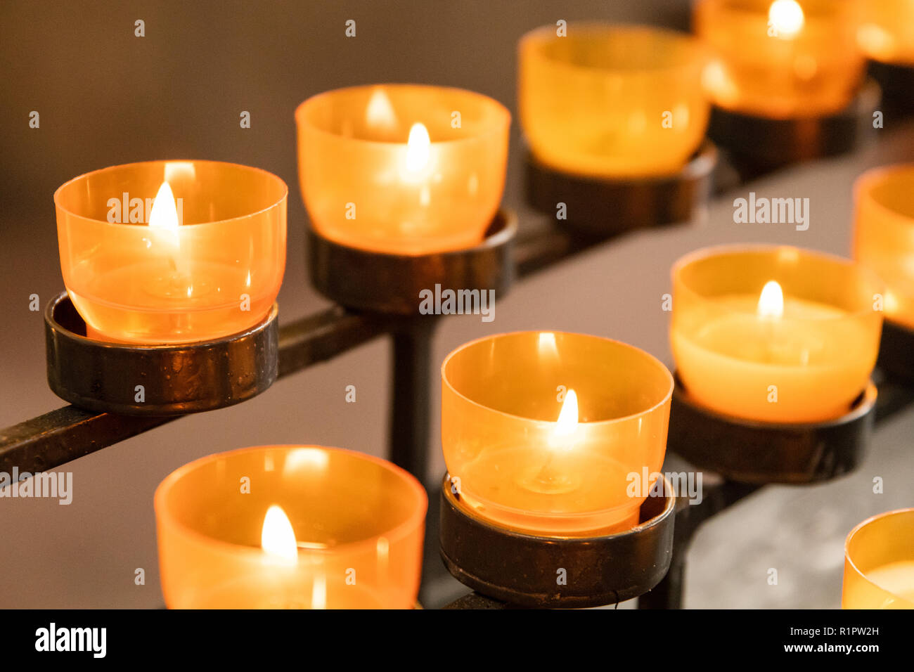 Lit church candles with warm light Stock Photo