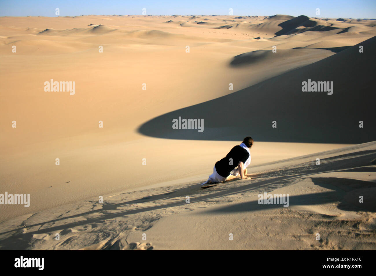Sandboarding wipe-out in Sahara desert near Siwa, Egypt Stock Photo