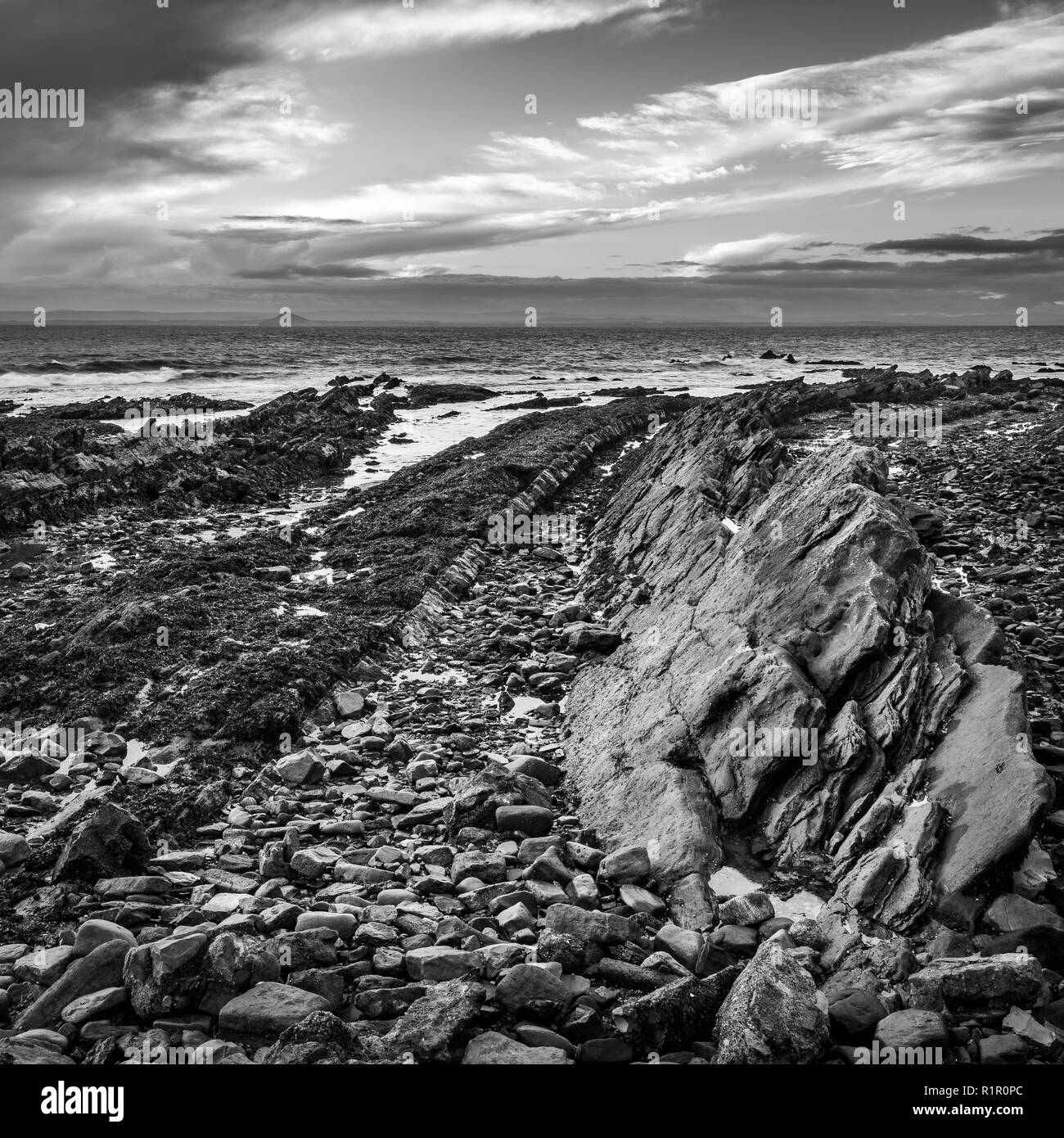 The rocky beach at St Monans in Fife, Scotland where volcanic rock formations protrude through the surface Stock Photo