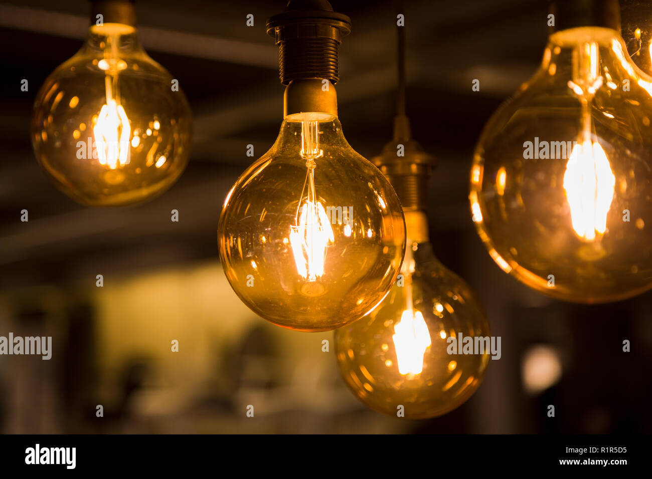 Cozy warm yellow light. Edison light bulb hanging. Closeup Stock