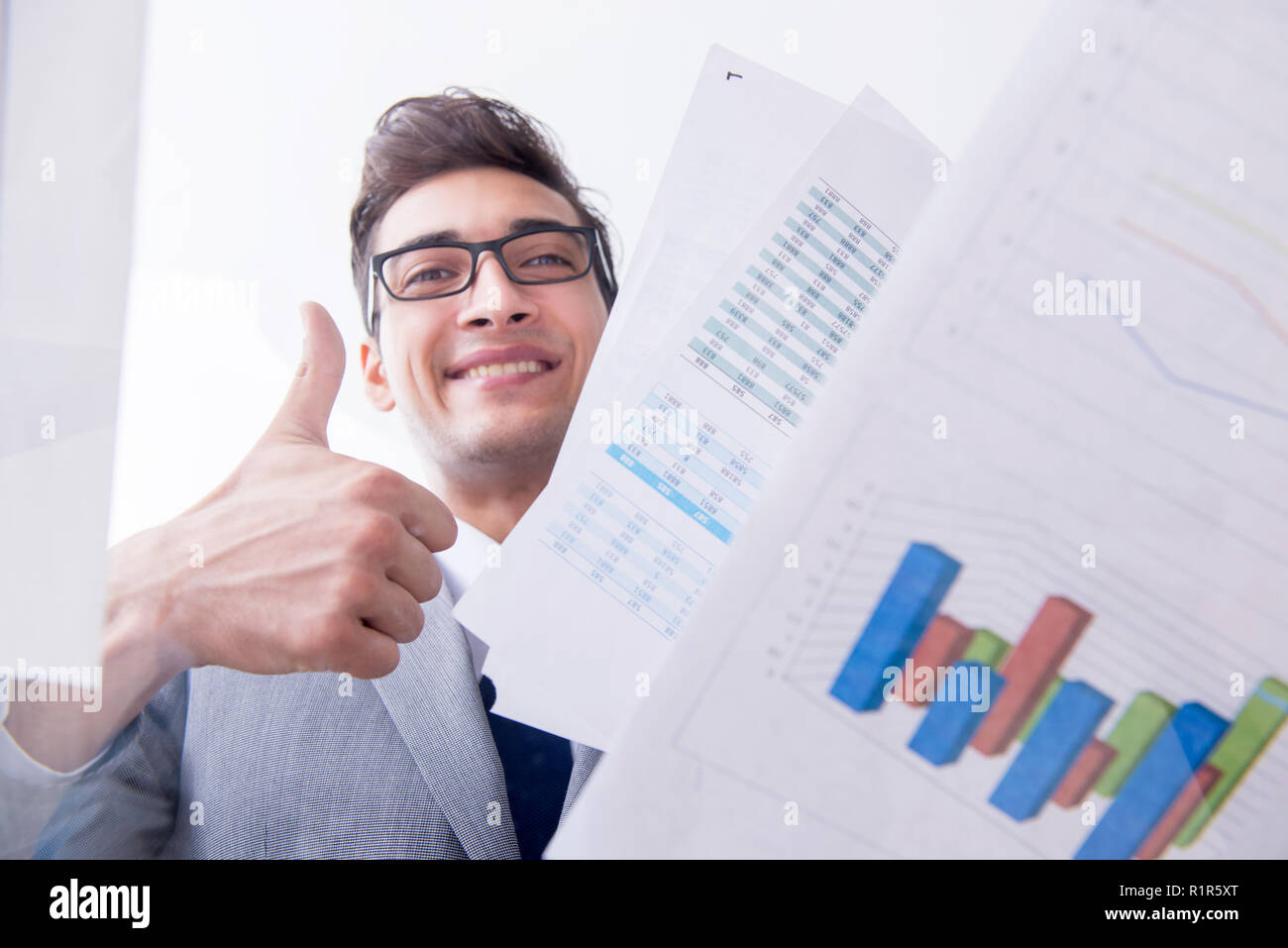 Businessman looking at financial charts and graphs stock photo alamy
