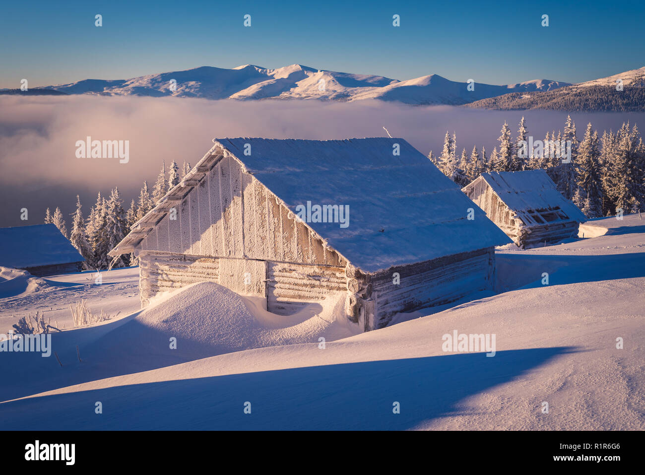 Winter landscape with wooden house in the frost. Mountain village of shepherds. Carpathians, Ukraine, Europe Stock Photo