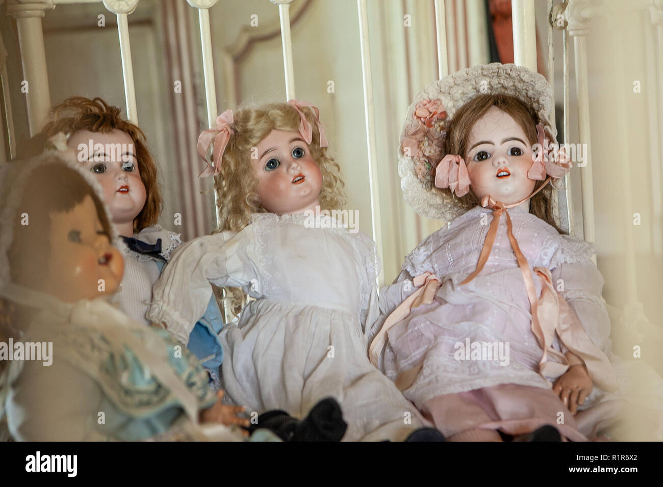 Collection of  victorian dolls in a bed Stock Photo