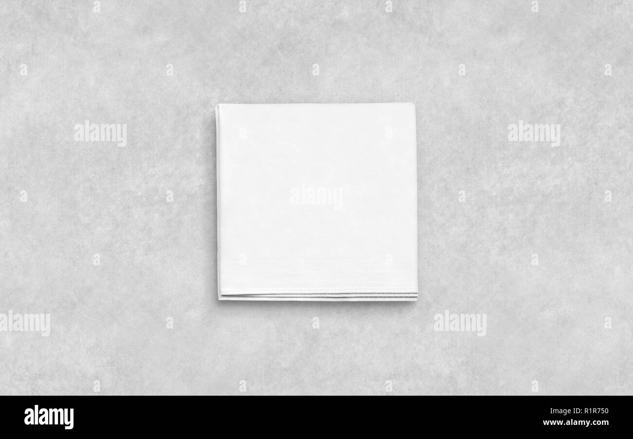 Blank white folded napkin on textured surface mockup. Empty square serviette mock up. Clear kitchen tablecloth for restaurant or dinning template. Hygiene textile towel design. Stock Photo