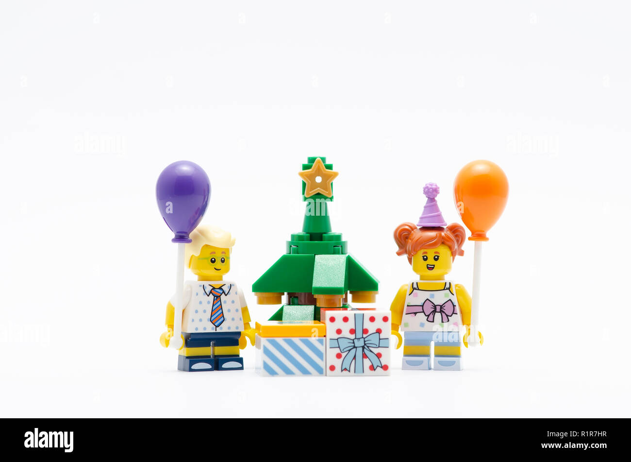 lego minifigure boy and girl holding ballon with christmas tree and gift  box. Lego minifigures are manufactured by The Lego Group Stock Photo - Alamy