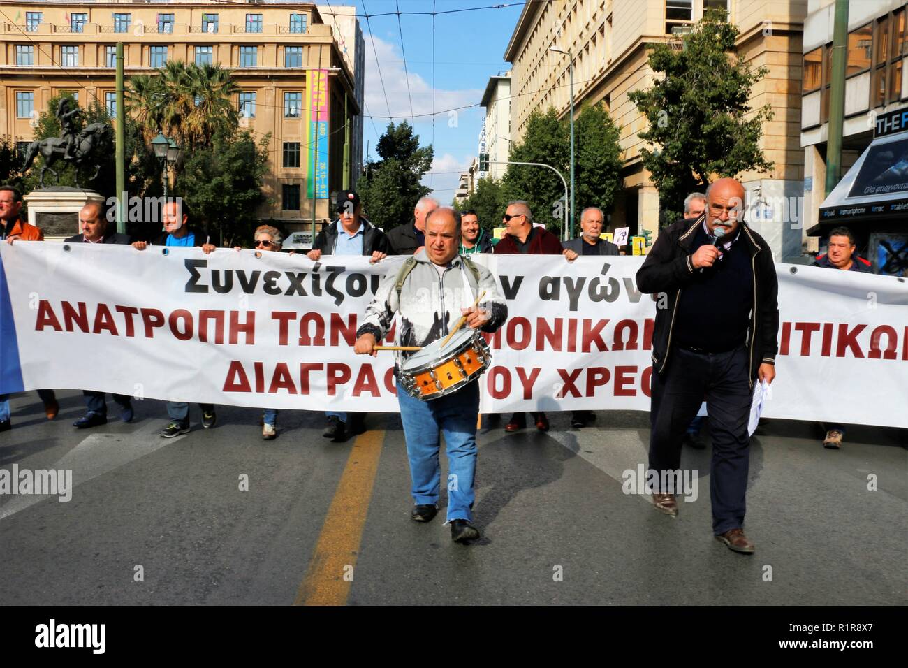 A protester is seen drumming during the strike. Greek Unions and private sector federation protest against further austerity measures and also demand for a better pay and changing the insurance draft. Stock Photo