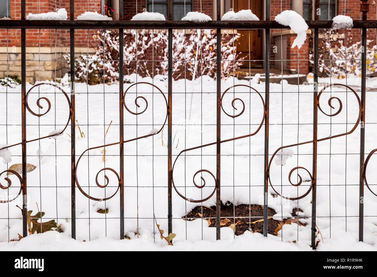 Snow covered decorative wrought iron fence; 839 F Street; Salida; Colorado; USA Stock Photo