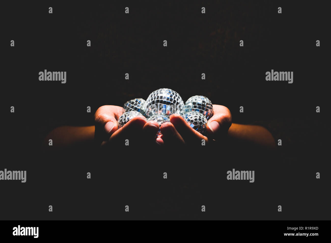 Woman holding disco balls Stock Photo