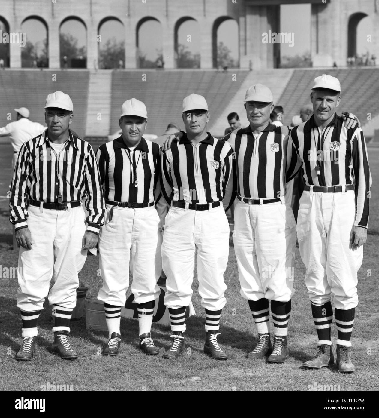 NFL refs pose for a group shot before a game at the Los Angeles Coliseum in the early 1950s. Stock Photo