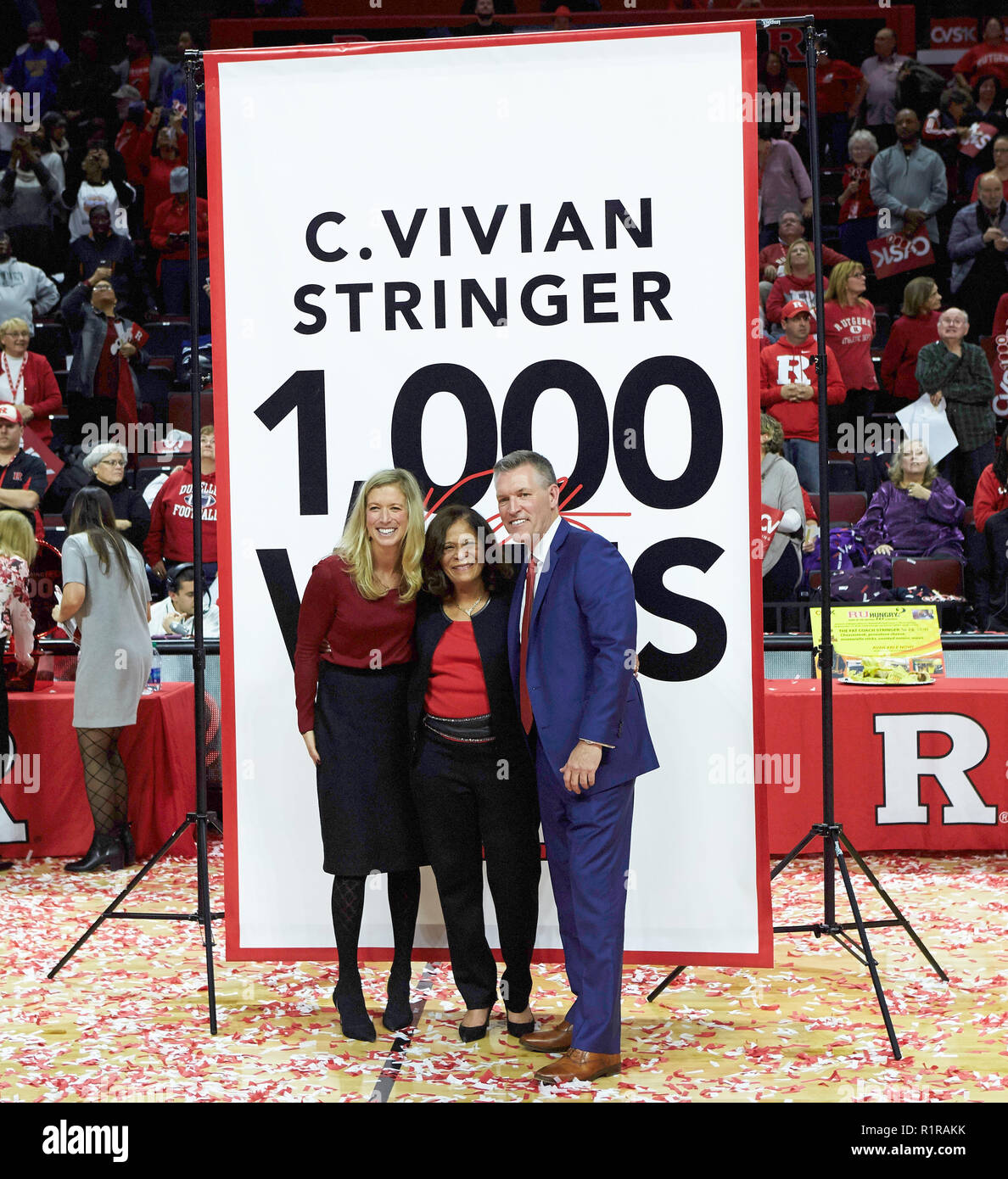 Piscataway, New Jersey, USA. 13th Nov, 2018. Rutgers Athletic Director Patrick Hobbs and Deputy Director of Athletics Sarah Baumgartner celebrate Rutgers women basketball head coach C. Vivian Stringer 1,000 career win after a game between the Rutgers Scarlet Knights and the Central Connecticut Blue Devils at Rutgers Athletic Center in Piscataway, New Jersey. Rutgers defeated Central Connecticut 74-44. Duncan Williams/CSM/Alamy Live News Stock Photo