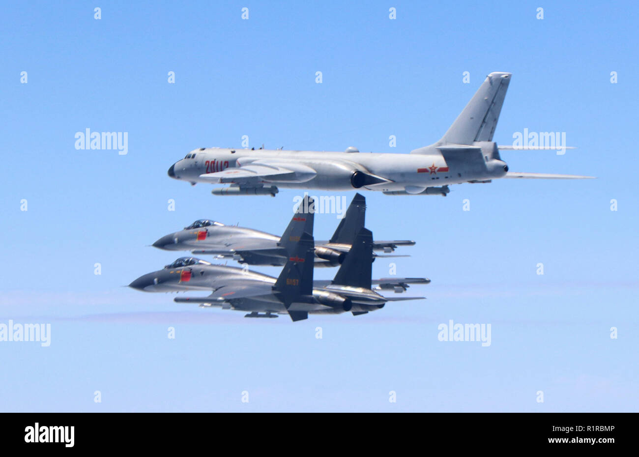 (181114) -- BEIJING, Nov. 14, 2018 (Xinhua) -- Two J-11 fighter jets and a H-6K bomber fly in formation on May 11, 2018. The Chinese Air Force announced a roadmap for building a stronger modern air force in three steps. The building of a stronger modern air force is in line with the overall goal of building national defense and the armed forces, Lieutenant General Xu Anxiang, deputy commander of Chinese Air Force, said at a press conference on celebrating the 69th anniversary of the establishment of Chinese Air Force held in Zhuhai, south China's Guangdong Province, Nov. 11, 2018. (Xinhua/Shao Stock Photo
