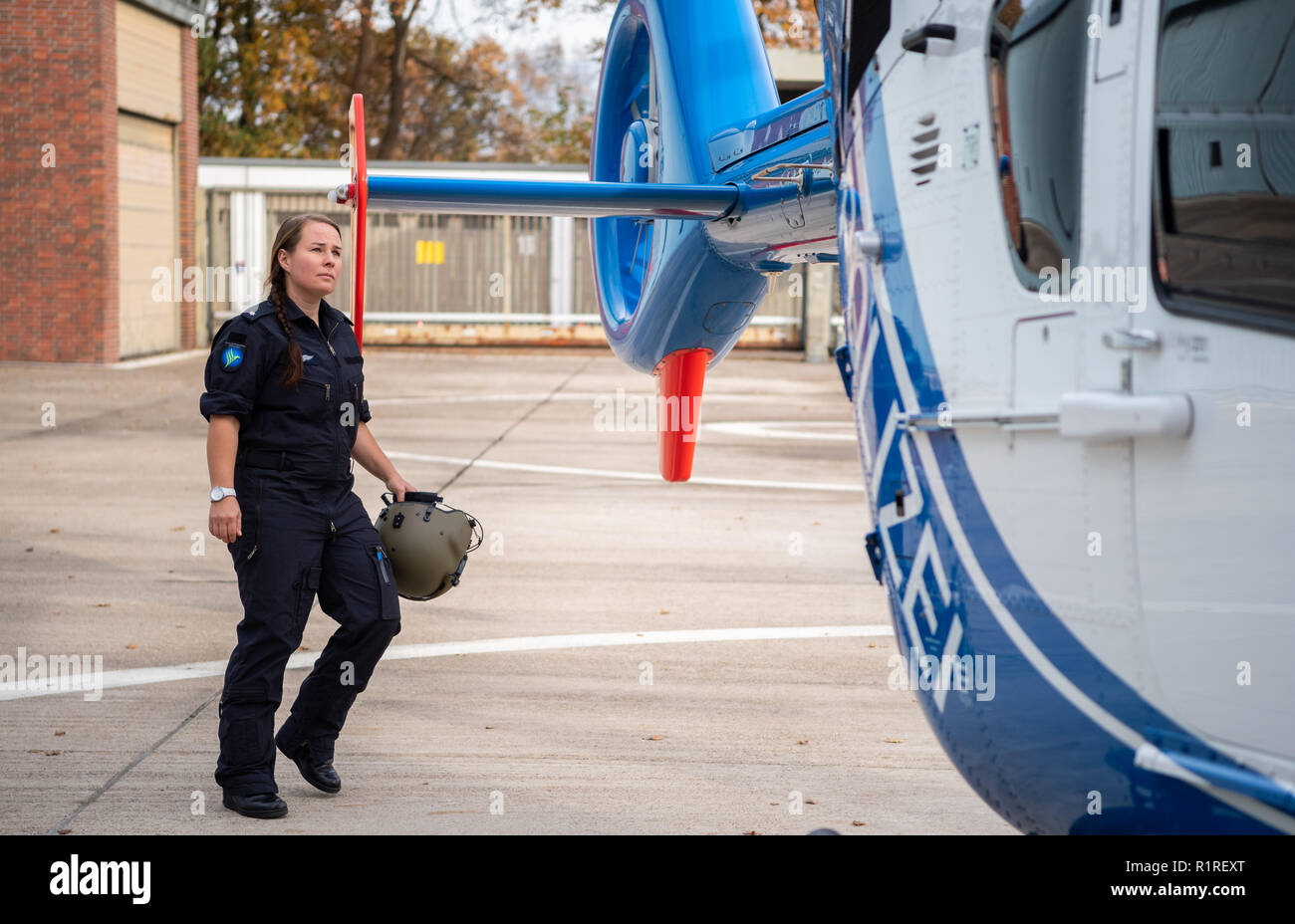 Rastede, Germany. 14th Nov, 2018. Kirsten Böning, first female helicopter pilot of the police of Lower Saxony, inspects a police helicopter shortly before she flies with the plane herself. Credit: Mohssen Assanimoghaddam/dpa/Alamy Live News Stock Photo