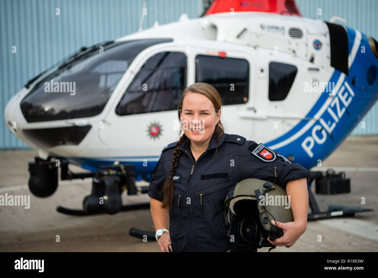Rastede, Germany. 14th Nov, 2018. Kirsten Böning, first female helicopter pilot of the police of Lower Saxony, stands in front of a police helicopter. Credit: Mohssen Assanimoghaddam/dpa/Alamy Live News Stock Photo