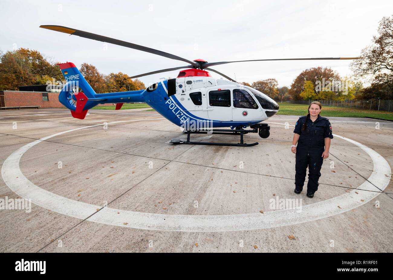 Rastede, Germany. 14th Nov, 2018. Kirsten Böning, first female helicopter pilot of the police of Lower Saxony, is standing in front of a police helicopter on a landing field. Credit: Mohssen Assanimoghaddam/dpa/Alamy Live News Stock Photo