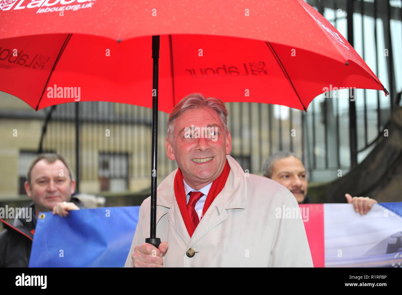 Edinburgh, UK. 14th Nov, 2018. Ahead of a Holyrood vote calling for the ScotRail break clause to be exercised, Scottish Labour leader Richard Leonard (seen taking cover from the rain) and Transport spokesperson Colin Smyth campaign at Waverley station. Credit: Colin Fisher/Alamy Live News Stock Photo