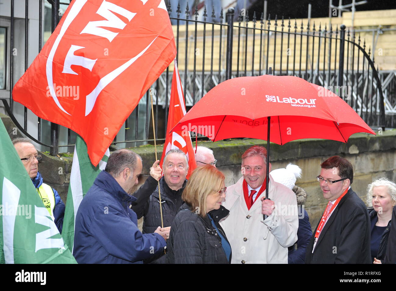 Edinburgh, UK. 14th Nov, 2018. Ahead of a Holyrood vote calling for the ScotRail break clause to be exercised, Scottish Labour leader Richard Leonard (seen taking cover from the rain) and Transport spokesperson Colin Smyth campaign at Waverley station. Credit: Colin Fisher/Alamy Live News Stock Photo