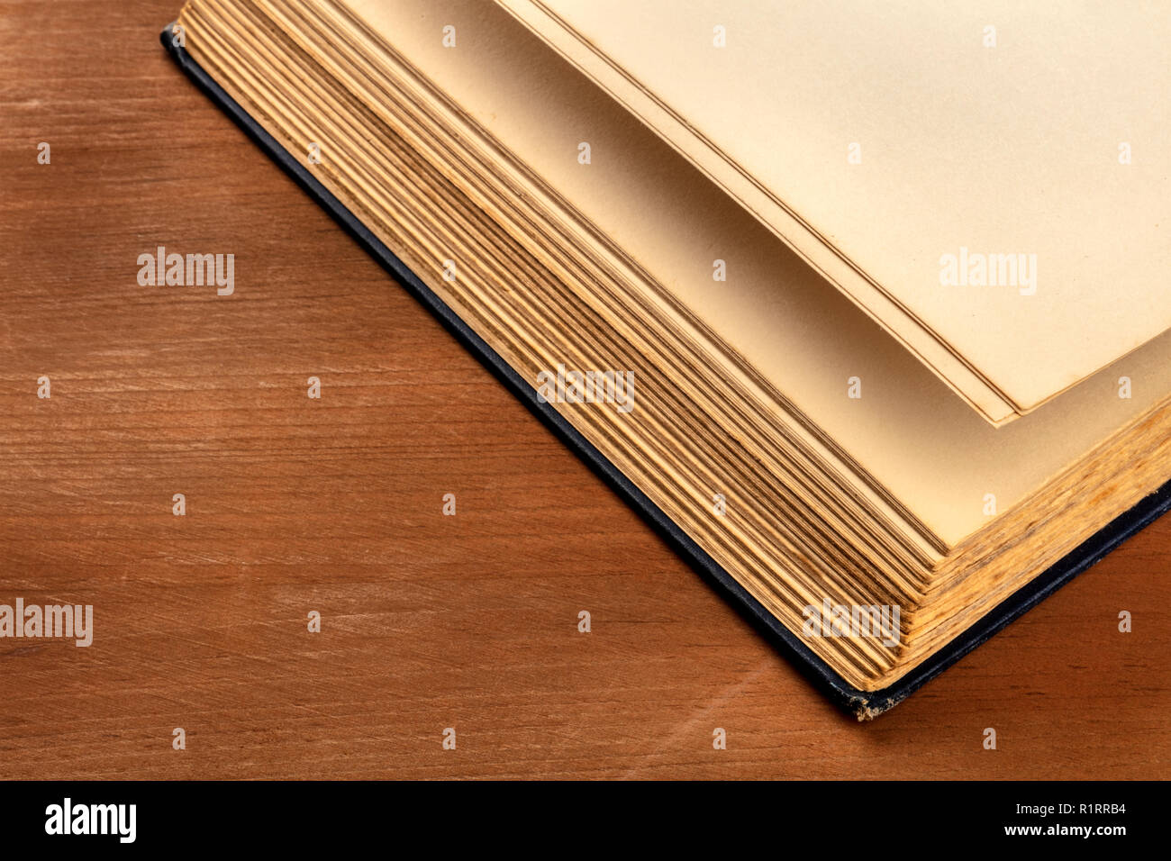 The pages of a thick old book on a dark rustic background with a place for text Stock Photo