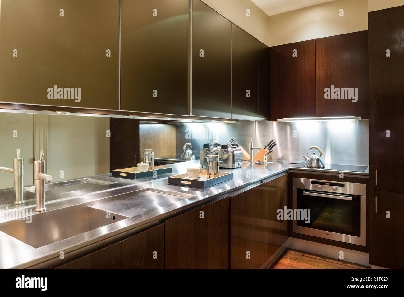 Modern kitchen with brown cupboards Stock Photo