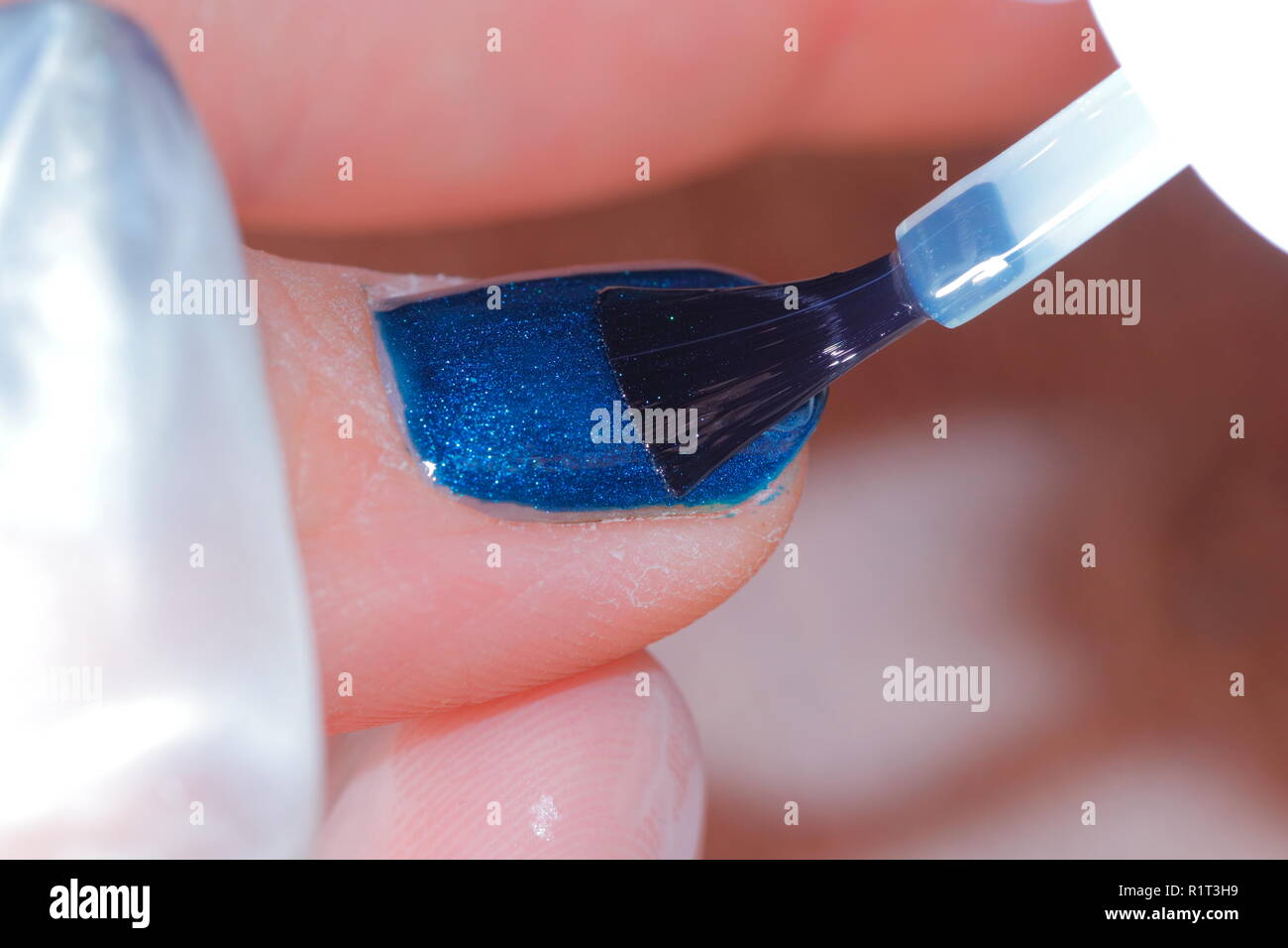 Nail polish being applied to a womans finger nails in a nail salon Stock Photo Alamy
