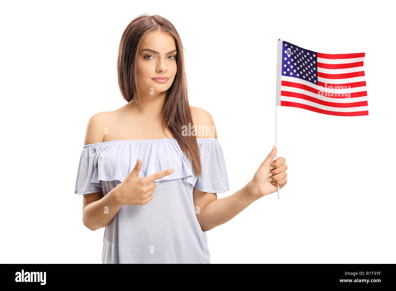 Young woman holding the flag of America and pointing isolated on white