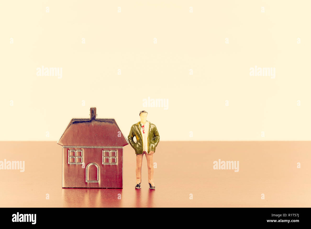 Miniature figure and metal house replica for property investment concept Stock Photo