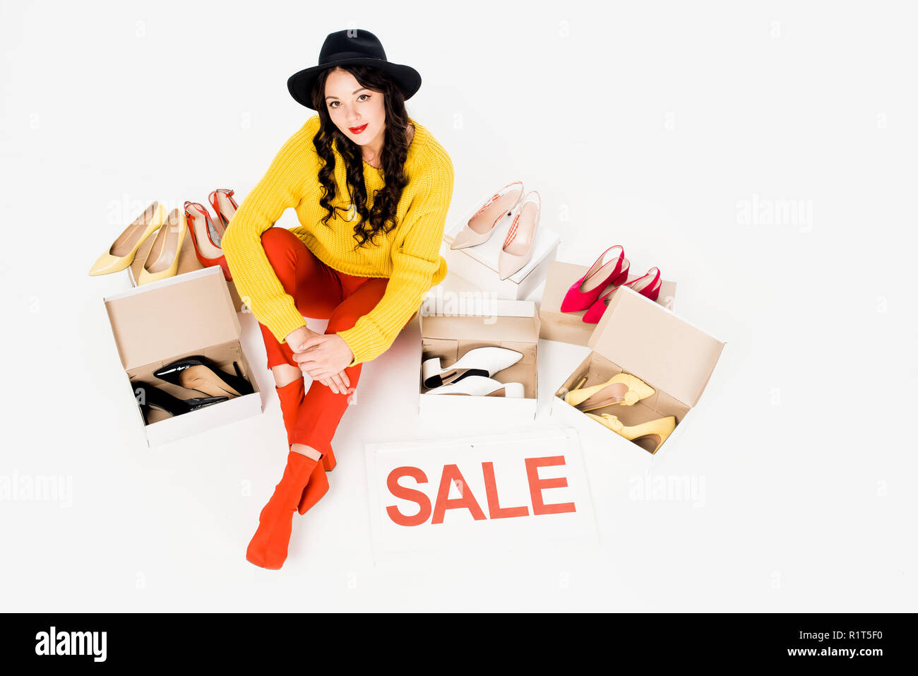 beautiful shopaholic with sale symbol isolated on white with footwear Stock Photo