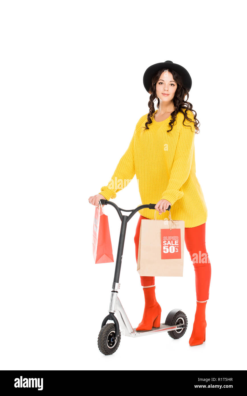 attractive customer riding scooter with shopping bags isolated on white Stock Photo