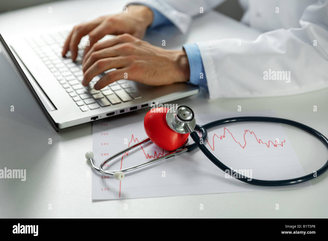 cardiology - doctor cardiologist working on laptop computer in office Stock Photo