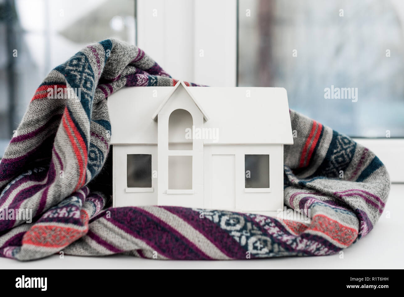 close-up shot of miniature house model with plaid on windowsill Stock Photo