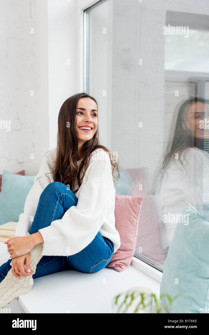 Woman relaxing on windowsill hi-res stock photography and images - Alamy