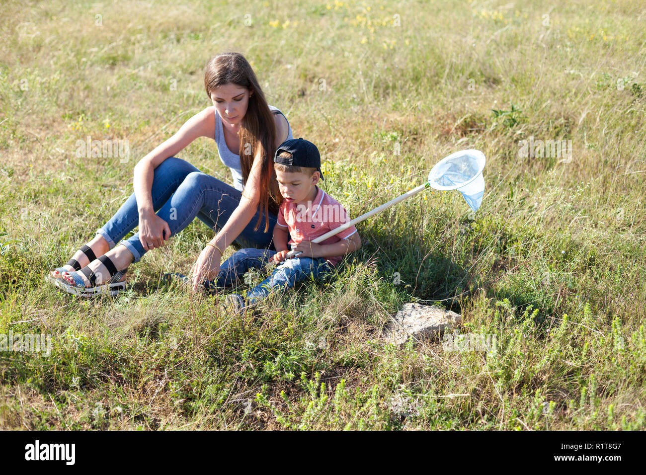 mother and young son catch insects butterflies Stock Photo - Alamy