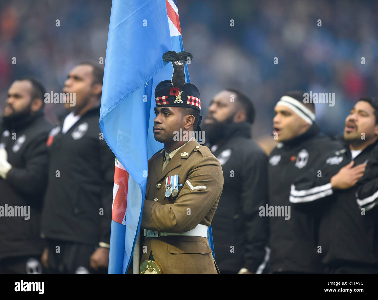 Scottish soldier holds the Fijian flag during national anthems during the Autumn International match at BT Murrayfield Stadium, Edinburgh. PRESS ASSOCIATION Photo. Picture date: Saturday November 10, 2018. See PA story RUGBYU Scotland. Photo credit should read: Ian Rutherford/PA Wire. Stock Photo