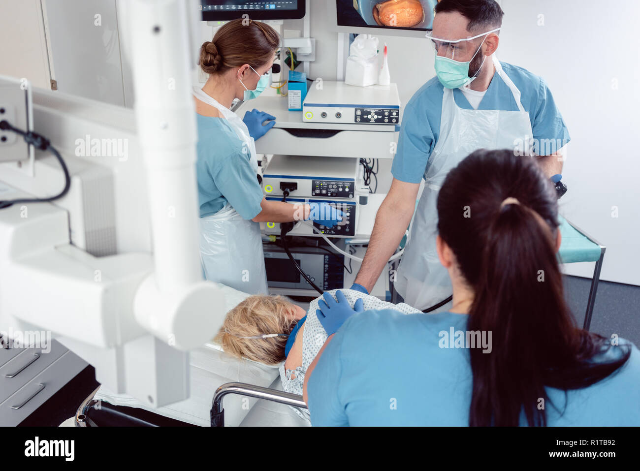 Team of doctors in hospital at endoscopy examining pictures during ...