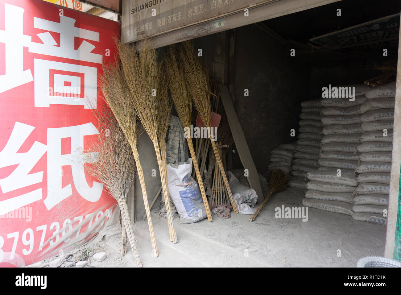 Traditional natural straw brooms for sale in Zingzhou China store Stock Photo