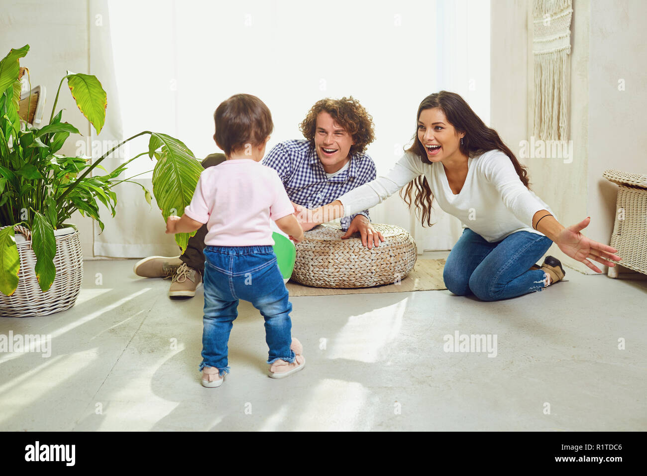 Happy family playing with the child indoors.  Stock Photo