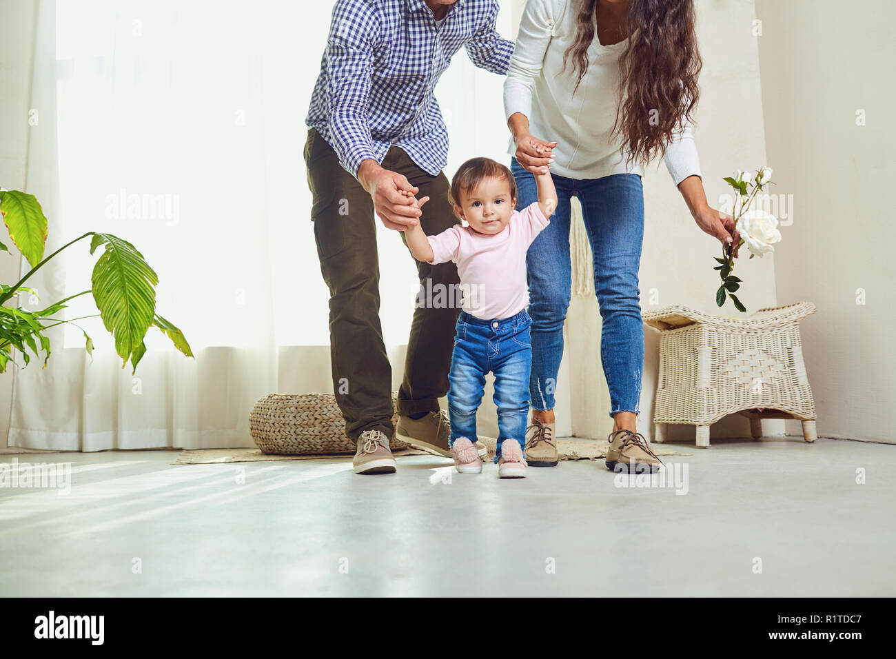 Happy family playing with the child indoors.  Stock Photo