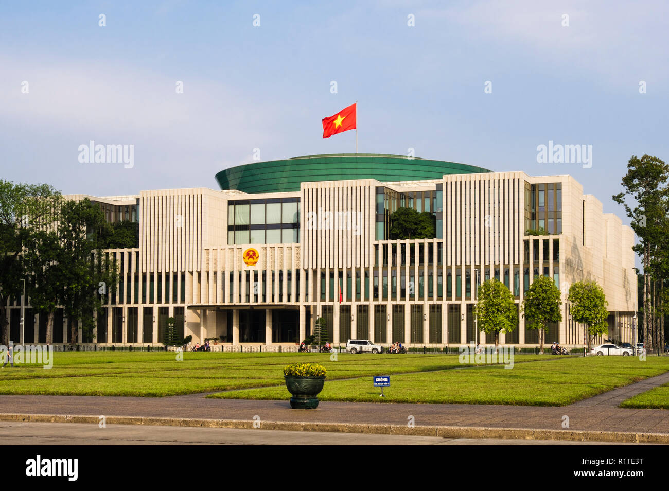 Vietnamese flag flying on new  21st century modern National Assembly House Parliament building. Hanoi, Vietnam, Asia Stock Photo