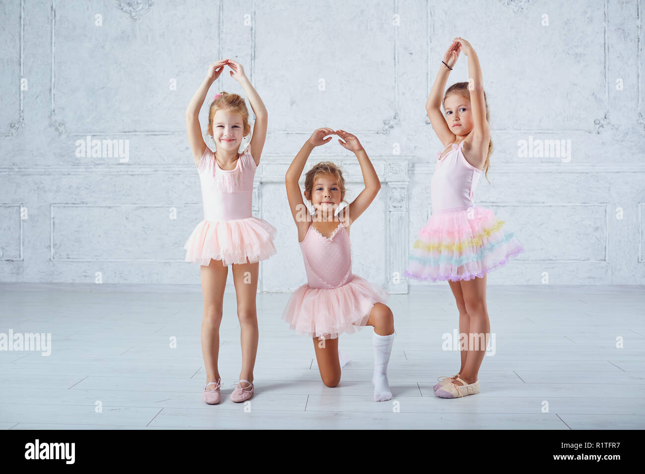 Children girls in ballerina costumes are engaged in dancing. Stock Photo