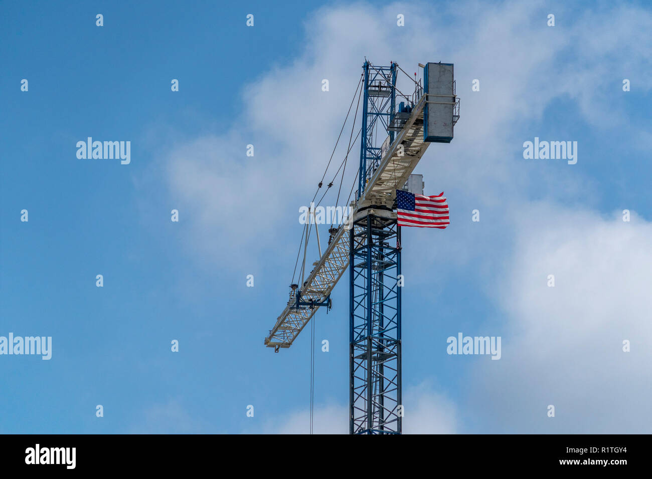 industrial big crane with american usa waving flag Stock Photo - Alamy