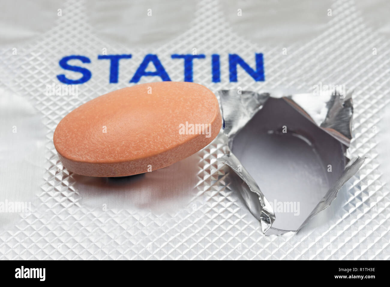 Close up of a generic statin tablet on a blister pack. Shallow depth of field. Logos removed Stock Photo