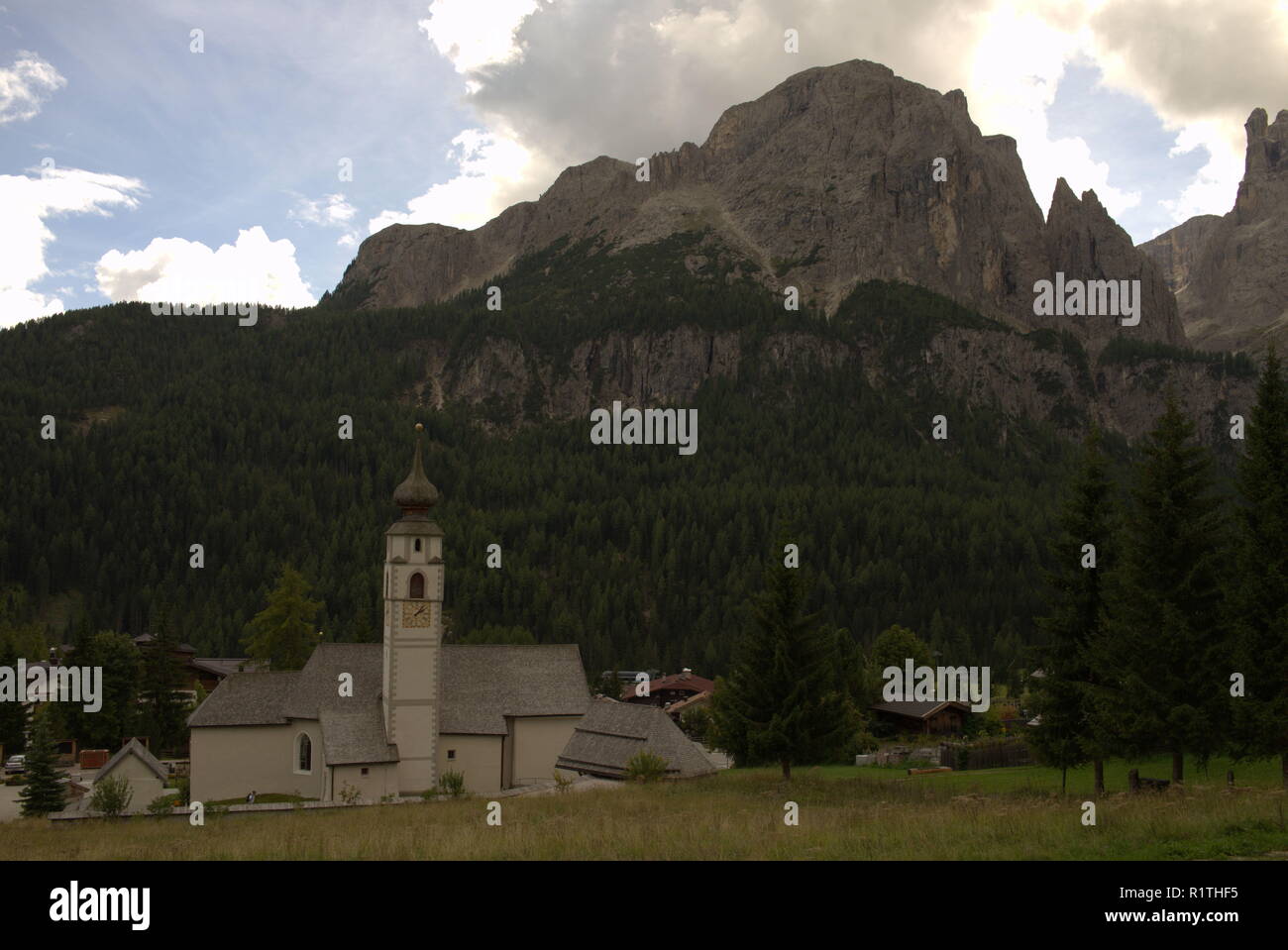 View to the Sella Group in the italian Dolomites, in front a typical alpine Church Stock Photo